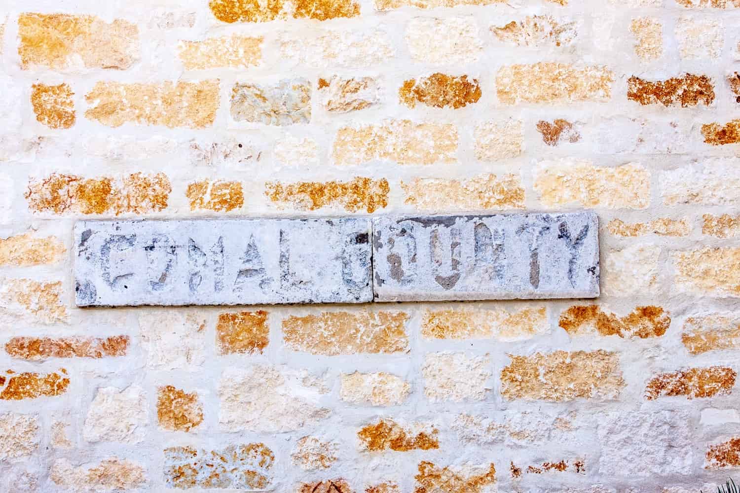 Canvas print Comal County metal plaque on Limestone